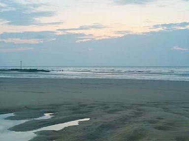 a beach scene with water and clouds at Lido Beach Holiday Park - Holiday Accommodation 21682, Prestatyn
