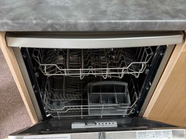 an open dishwasher with racks and a silver control panel at Clarach Bay Holiday Village - Holiday Accommodation 21850, Aberystwyth