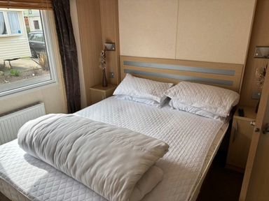 a bedroom with a double bed and nightstands at Clarach Bay Holiday Village - Holiday Accommodation 21850 Aberystwyth