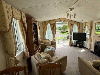 a living room with a TV and comfortable seating at Butlins Skegness - Holiday Accommodation 22071 in Ingoldmells