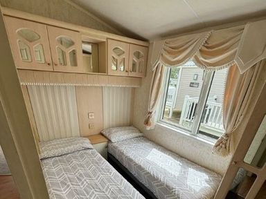 a bedroom with two single beds and a window at Butlins Skegness - Holiday Accommodation 22071 in Ingoldmells