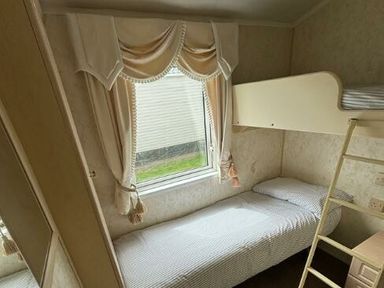 a small bedroom with a single bed and a bunk bed in Butlins Skegness - Holiday Accommodation 22071 in Ingoldmells