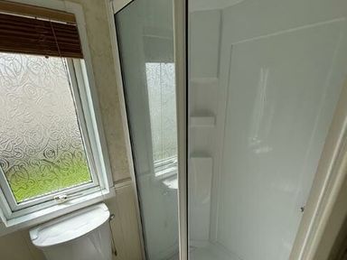 a bathroom featuring a shower cubicle and a window at Butlins Skegness - Holiday Accommodation 22071 in Ingoldmells