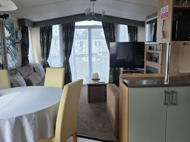 A living room with furniture and a television at Ty Gwyn Caravan Park - Holiday Accommodation 22189 Abergele