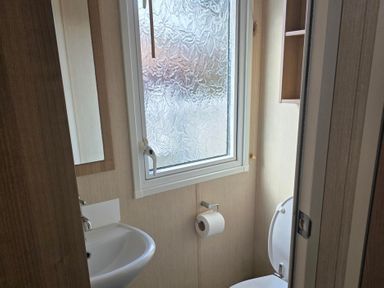 A bathroom with a sink and toilet at Ty Gwyn Caravan Park - Holiday Accommodation 22189 Abergele