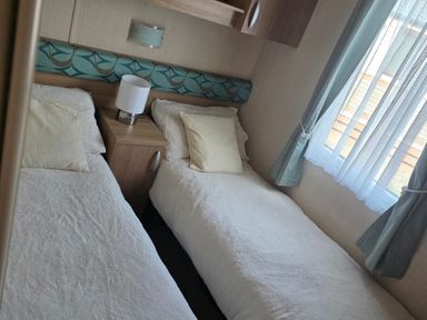A bedroom with two single beds at Ty Gwyn Caravan Park - Holiday Accommodation 22189 Abergele
