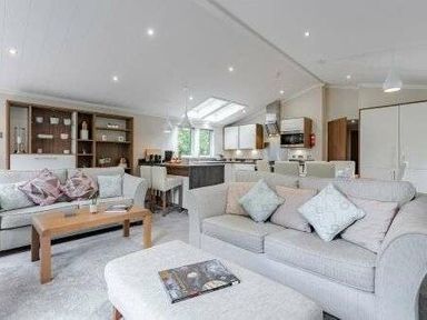 a living room with sofas and a coffee table at Kelling Heath Holiday Park - Holiday Accommodation 22249 in Holt