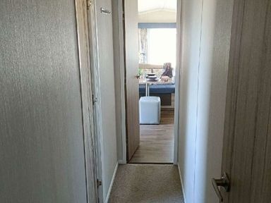 a hallway leading to a room with a dining area at Lyons Winkups and Primrose - Holiday Accommodation 22330, Towyn