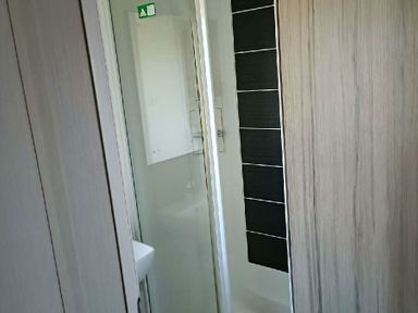 a bathroom with a shower and sink at Lyons Winkups and Primrose - Holiday Accommodation 22330 Towyn
