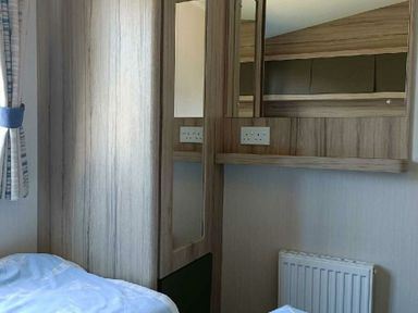 a bedroom with mirrors and a shelf at Lyons Winkups and Primrose - Holiday Accommodation 22330 Towyn