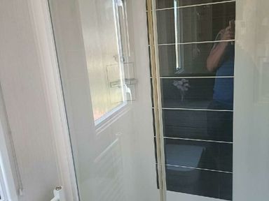 a modern bathroom featuring a shower stall and tiled wall at Lyons Winkups and Primrose - Holiday Accommodation 22330 Towyn