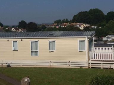 a static caravan with multiple windows and a deck at Waterside, Paignton - Holiday Accommodation 2287, Paignton