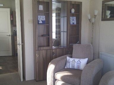a living room with a glass-fronted cabinet and an armchair at Waterside, Paignton - Holiday Accommodation 2287, Paignton