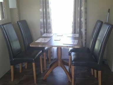 a dining area with a square table and four chairs at Waterside, Paignton - Holiday Accommodation 2287, Paignton