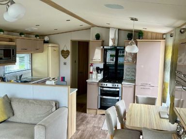 a kitchen and living area with modern furnishings at Lakeland Leisure Park - Holiday Accommodation 3166 Flookburgh