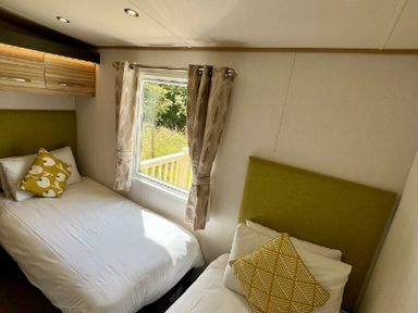 a bedroom with two single beds and a window at Lakeland Leisure Park - Holiday Accommodation 3166 Flookburgh