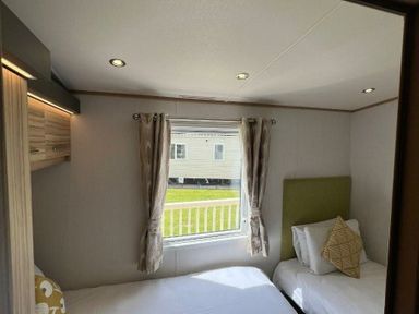 a bedroom with twin beds and a window at Lakeland Leisure Park - Holiday Accommodation 3166 in Flookburgh