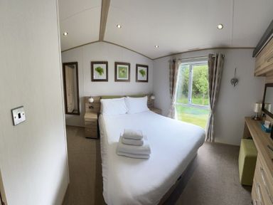 a bedroom with a double bed and window at Lakeland Leisure Park - Holiday Accommodation 3166, Flookburgh
