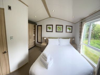 a bedroom with a double bed and storage unit at Lakeland Leisure Park - Holiday Accommodation 3166 in Flookburgh