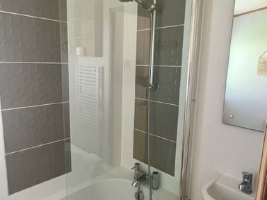 a bathroom with a shower and bathtub at Lakeland Leisure Park - Holiday Accommodation 3166, Flookburgh