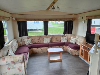 a living room with a large sectional sofa and a coffee table at Seven Bays Park (Maribou) - Holiday Accommodation 3966, St Merryn