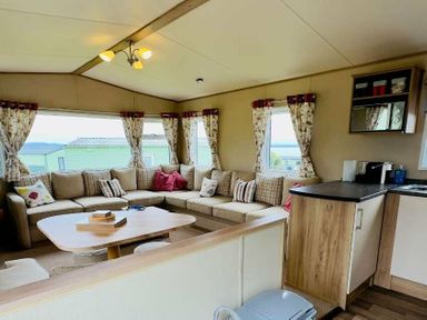 a living room with a sofa, cushions, and a table at St Andrews Holiday Park - Holiday Accommodation 609 in St. Andrews