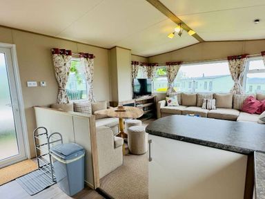 a living room with a sofa, television and dining table at St Andrews Holiday Park - Holiday Accommodation 609 in St. Andrews