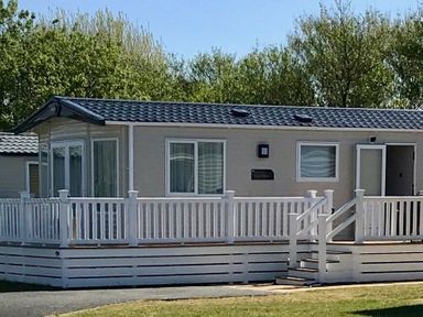 a holiday home with a porch and steps at Greenacres Holiday Park - Holiday Accommodation 6757 in Porthmadog