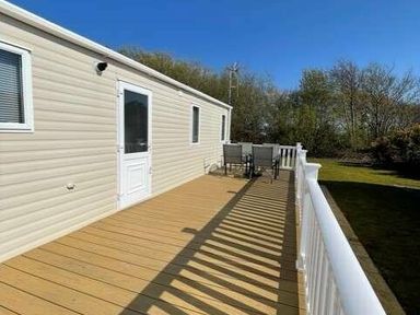 a deck with outdoor seating at Greenacres Holiday Park - Holiday Accommodation 6757 in Porthmadog