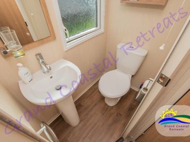 a small bathroom with a sink and toilet at Devon Cliffs Holiday Park - Holiday Accommodation 6955 in Exmouth