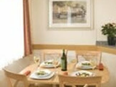 a dining area with a table set for four at Perran Sands - Holiday Accommodation 8131 in Perranporth