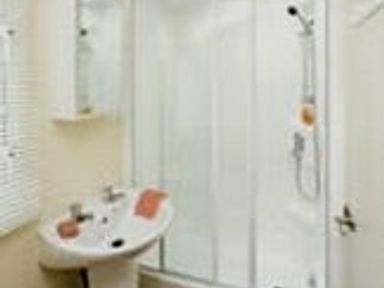 a bathroom with a shower stall and a sink at Perran Sands - Holiday Accommodation 8131 in Perranporth