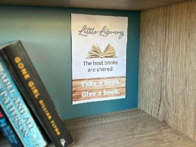 a sign about a little library encouraging book sharing at Butlins Minehead - Holiday Accommodation 826 in Minehead