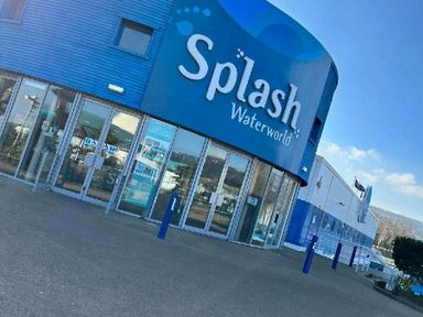 a building with a blue exterior and signage reading Splash Waterworld at Butlins Minehead - Holiday Accommodation 826 in Minehead