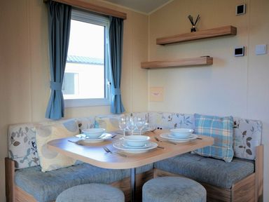 a dining area with a table set for four people at Perran Sands - Holiday Accommodation 8302, Perranporth