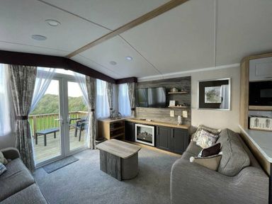 a living room with a television and a coffee table at Perran Sands - Holiday Accommodation 8982 Perranporth