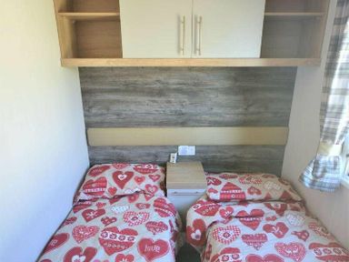 a bedroom with two beds covered in heart-patterned blankets at Perran Sands - Holiday Accommodation 8982, Perranporth