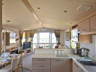 a kitchen and dining area with a view at Perran Sands - Holiday Accommodation 9657 in Perranporth
