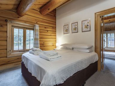A bedroom with a bed and window at Kinder Lodge (Pet) Fowlis near Dundee