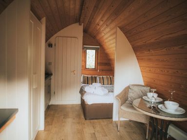 A studio with a bed and a table at Garden Pod in Waltham