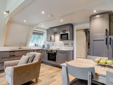 A kitchen with a table and chairs at St Ives Studio in Praze-An-Beeble