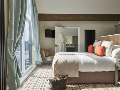 A bedroom with a bed and a window at Ferry Hills in Laugharne
