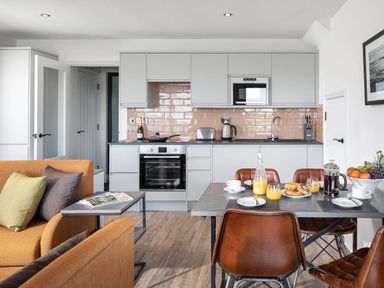 A kitchen with modern furniture and breakfast items at Ferry Hills in Laugharne