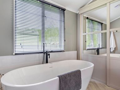 A bathroom with a bathtub and sink at Prion Spa in Llandyrnog