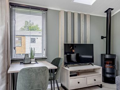 A living room with a table and chairs at Prion Spa in Llandyrnog