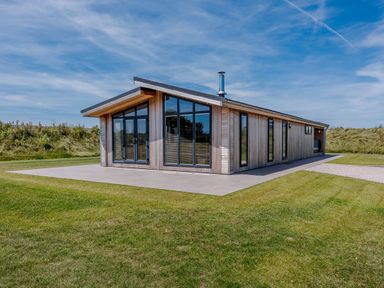 A house with large windows and a patio at Darwin Retreat in Wigton