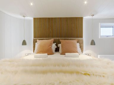 A bedroom with a bed and lamps at The Sheraton Retreat in Wigton