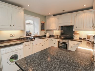 A kitchen with a washing machine and countertop at 21 High Street in Scarborough