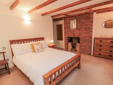 A bedroom with a bed and a fireplace at 21 High Street, Scarborough