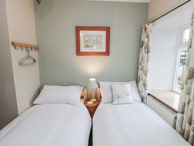 A bedroom with two beds and a window at 21 High Street, Scarborough